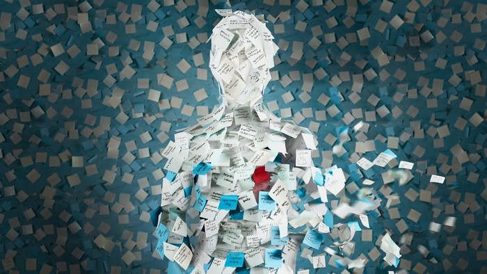 Human silhouette covered in sticky notes