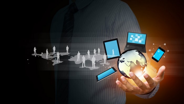 Man holding globe with technology and people network