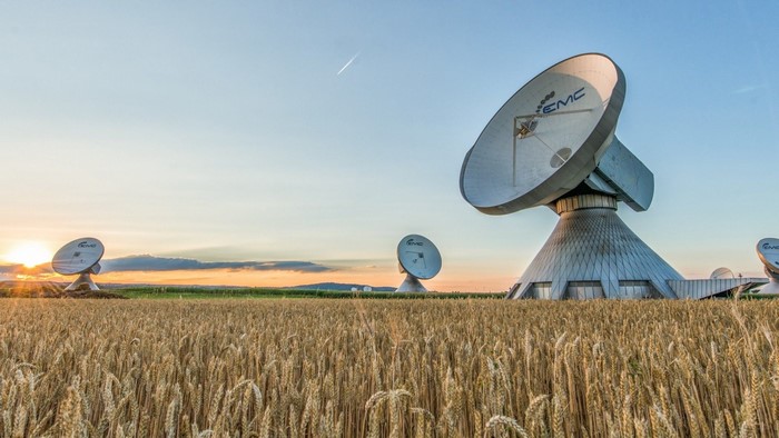 Satellite Dishes in a Wheat Field at Sunset