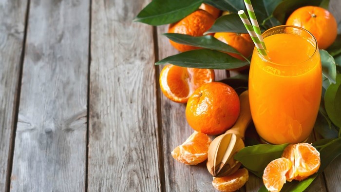 Orange Juice with Oranges and Leaves