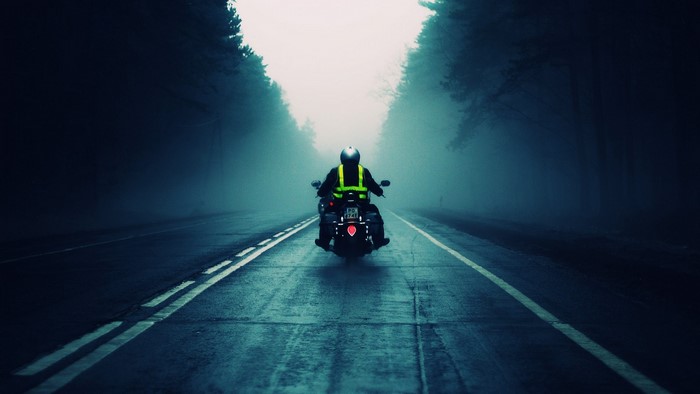 Motorcyclist on a foggy road