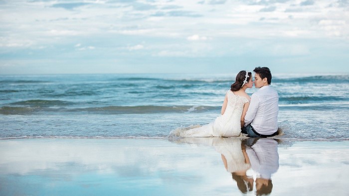 Couple in Wedding Attire on Beach