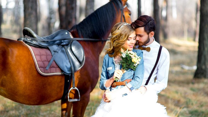 Couple with horse in forest