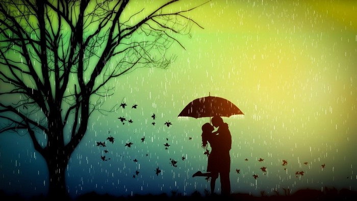 Couple kissing under umbrella in rain