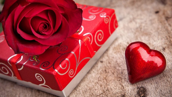 Red rose on gift box with heart