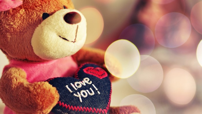 Teddy bear holding "I love you" heart