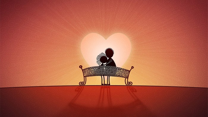 Couple on a bench in front of a heart-shaped sunset