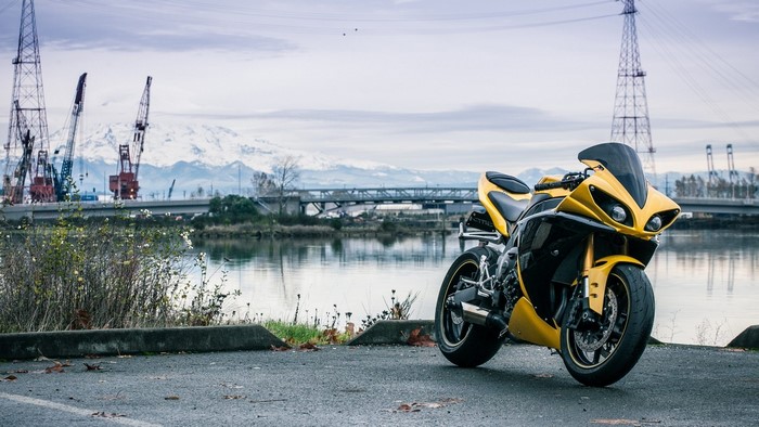 Yellow Yamaha YZF motorcycle by the water