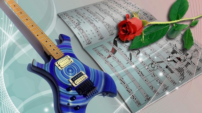 Electric guitar with sheet music and a red rose