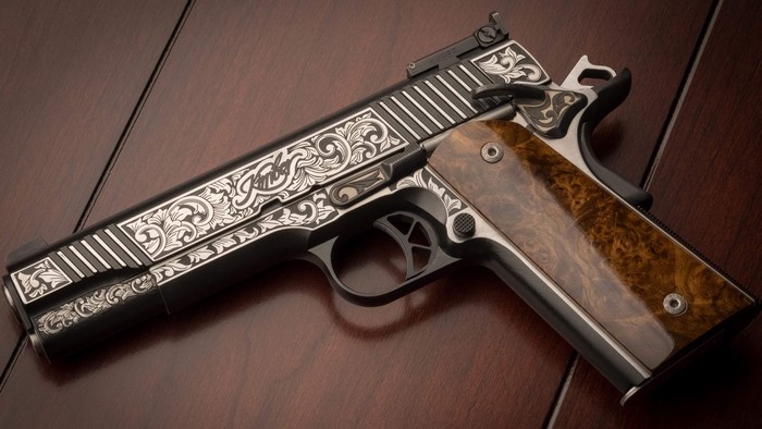 Engraved Kimber 1911 pistol with wood grips