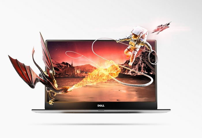 Dell laptop with astronaut, dragon, and spaceship