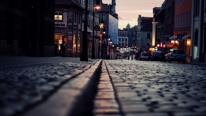 Cobblestone street in a European city at dusk