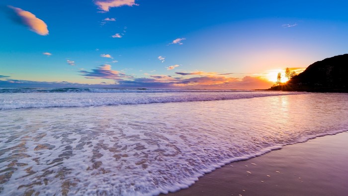 Beach Sunrise with Waves and Hill