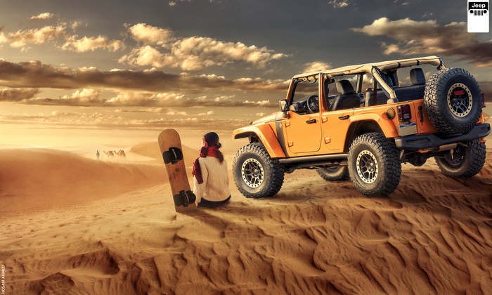 Girl with snowboard and Jeep Wrangler in desert