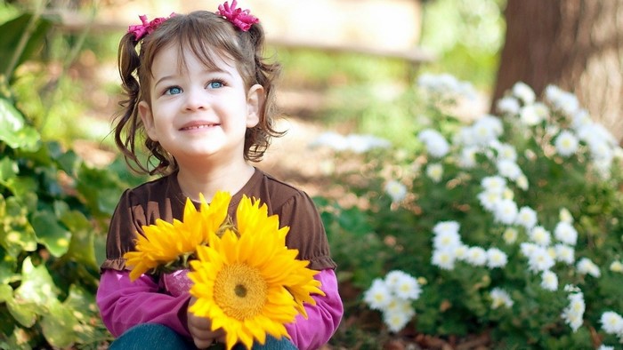 Little Girl Holding Sunflowers