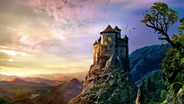 Fantasy castle on a rocky mountain at sunset