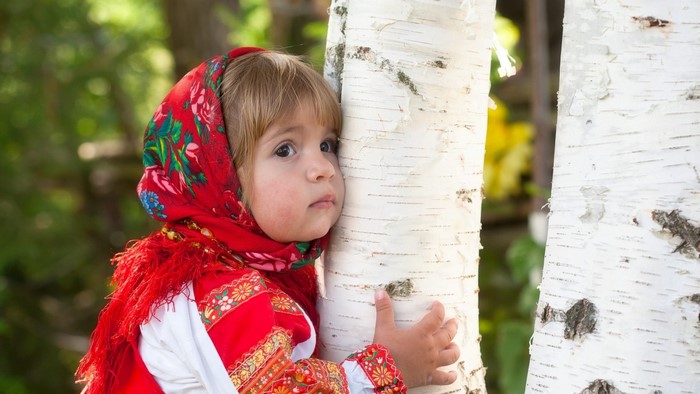 Cute baby girl in traditional Russian clothing