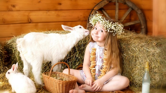 Girl with a flower crown and a goat