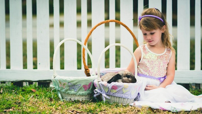 Girl with rabbit in Easter baskets