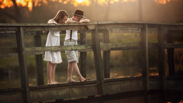 Boy and Girl on a Wooden Bridge