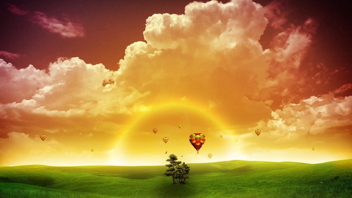 Surreal sunset with hot air balloons over a green field