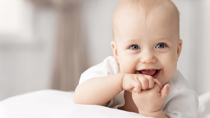 Baby smiling with blue eyes