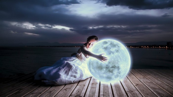 Girl hugging a glowing moon