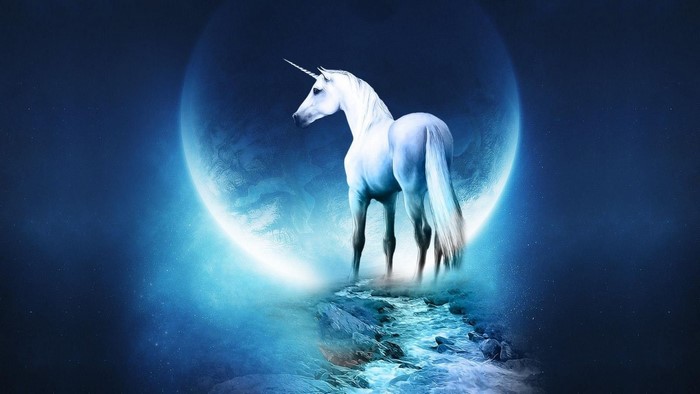 Unicorn standing on a rocky shore with a large moon behind