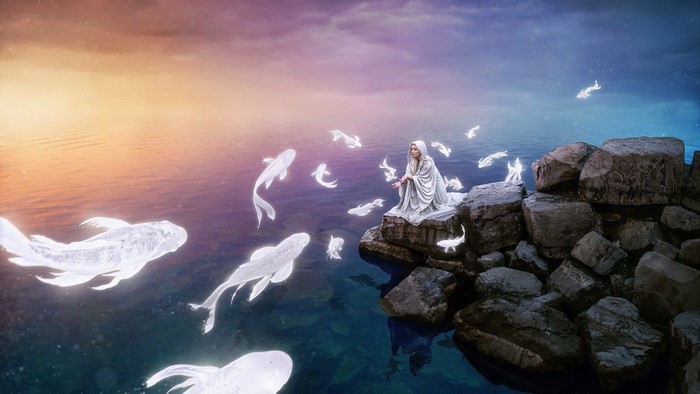 Fantasy woman with glowing fish by rocky shore