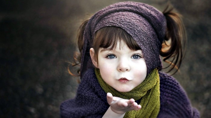 Cute girl blowing an air kiss