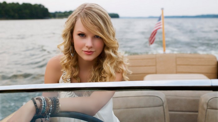 Taylor Swift on a boat with American flag