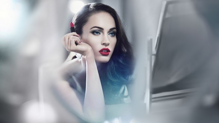 Megan Fox applying red lipstick