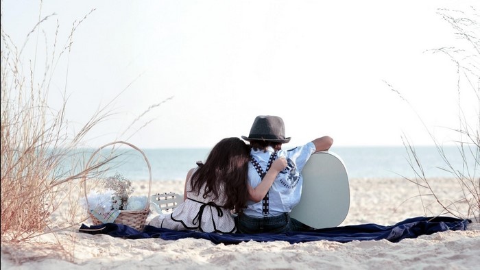 Children with guitar on beach