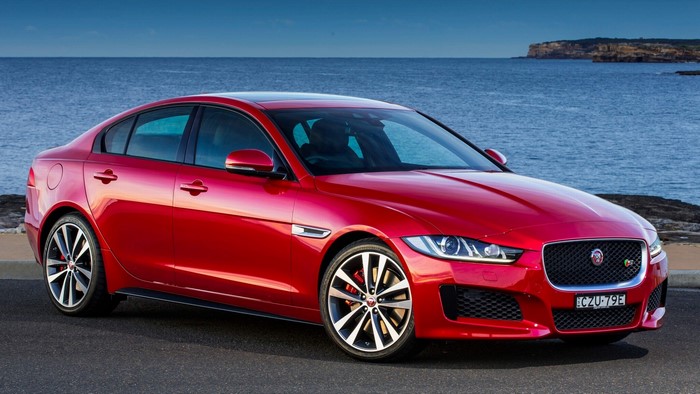 Red Jaguar XE Sedan by the Ocean