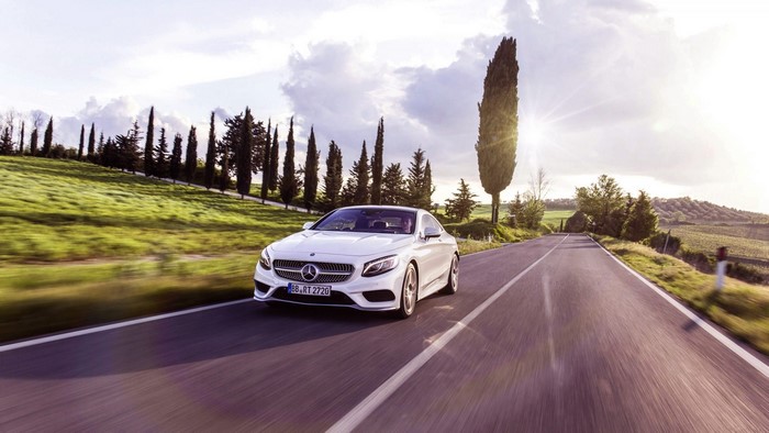 White Mercedes S Class Coupe driving on a road
