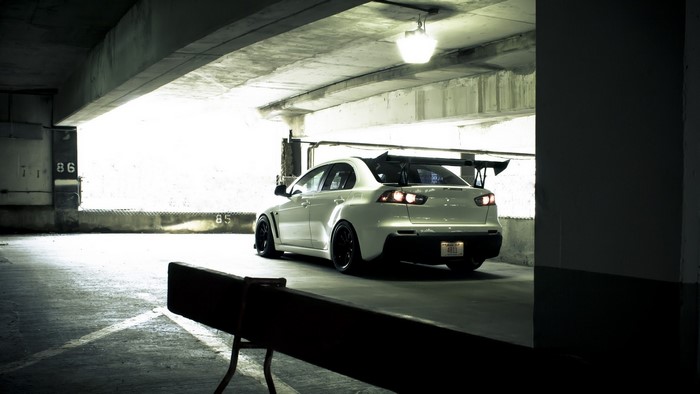White Mitsubishi Lancer Evolution Sports Sedan in Parking Garage