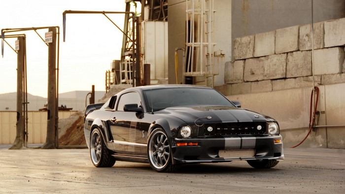 Black Shelby GT350 Mustang in industrial area