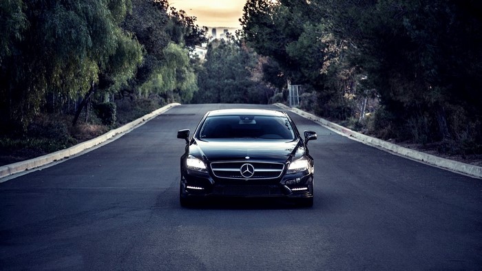Black Mercedes-Benz CLS550 on a Road at Sunset