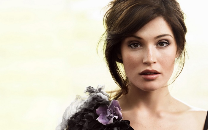 Gemma Arterton portrait with floral shoulder accessory