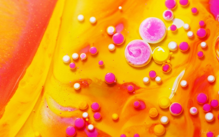 Abstract fluid art with pink and yellow bubbles