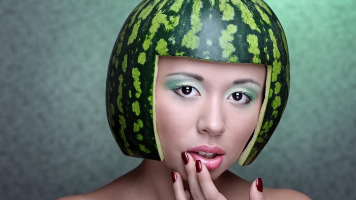 Woman with a watermelon as a hat