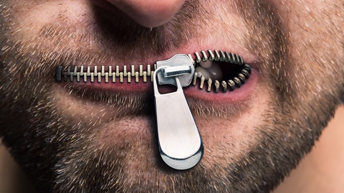 Man's mouth zipped shut with a zipper
