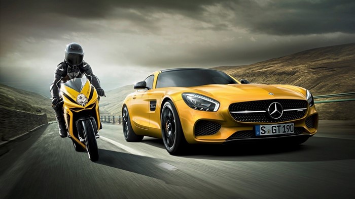 Yellow MV Agusta F3 and Mercedes-AMG GT S on a road