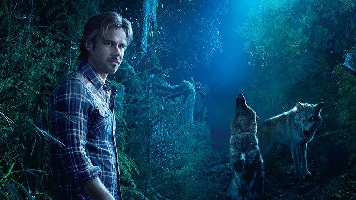 Sam Merlotte from True Blood in a forest with wolves