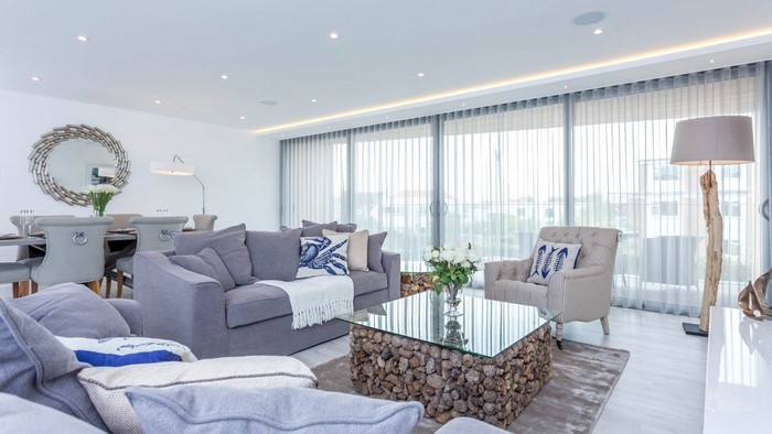 Modern living room with gray sofas and large windows