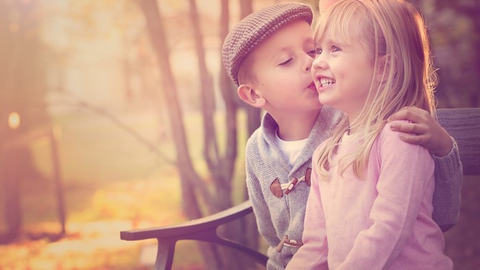 Boy kissing a girl on the cheek