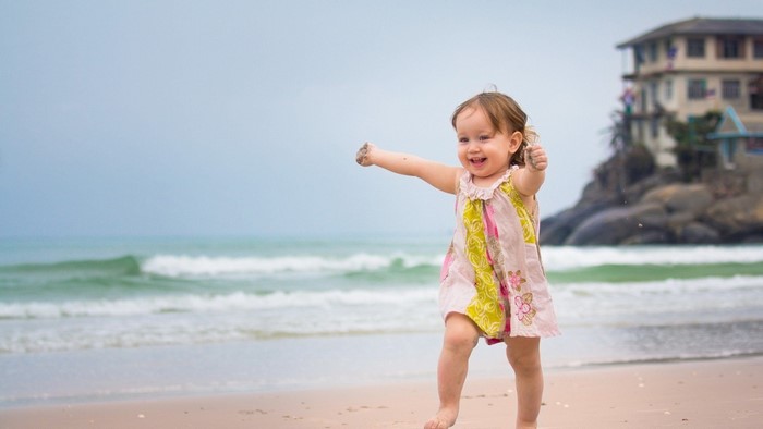 Cute baby girl smiling on a beach