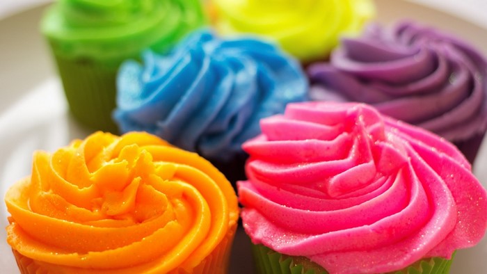 Assortment of colorful frosted cupcakes