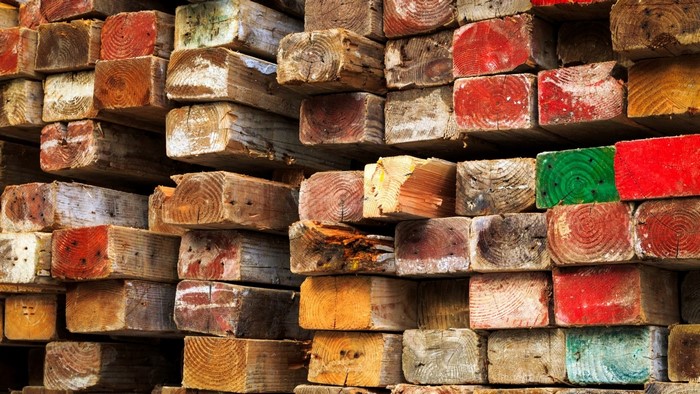 Stacked colored and weathered wooden beams