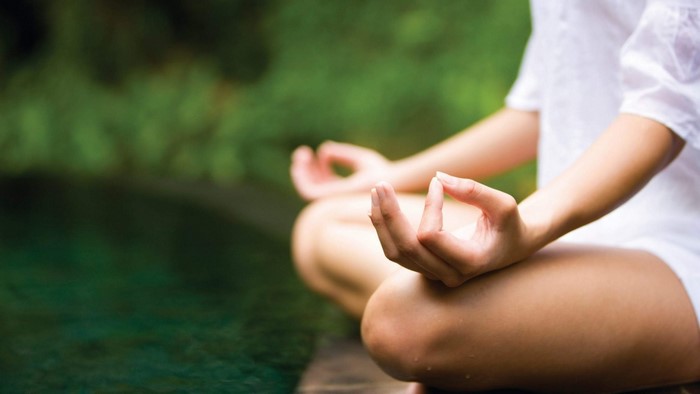 Person meditating in a lotus pose